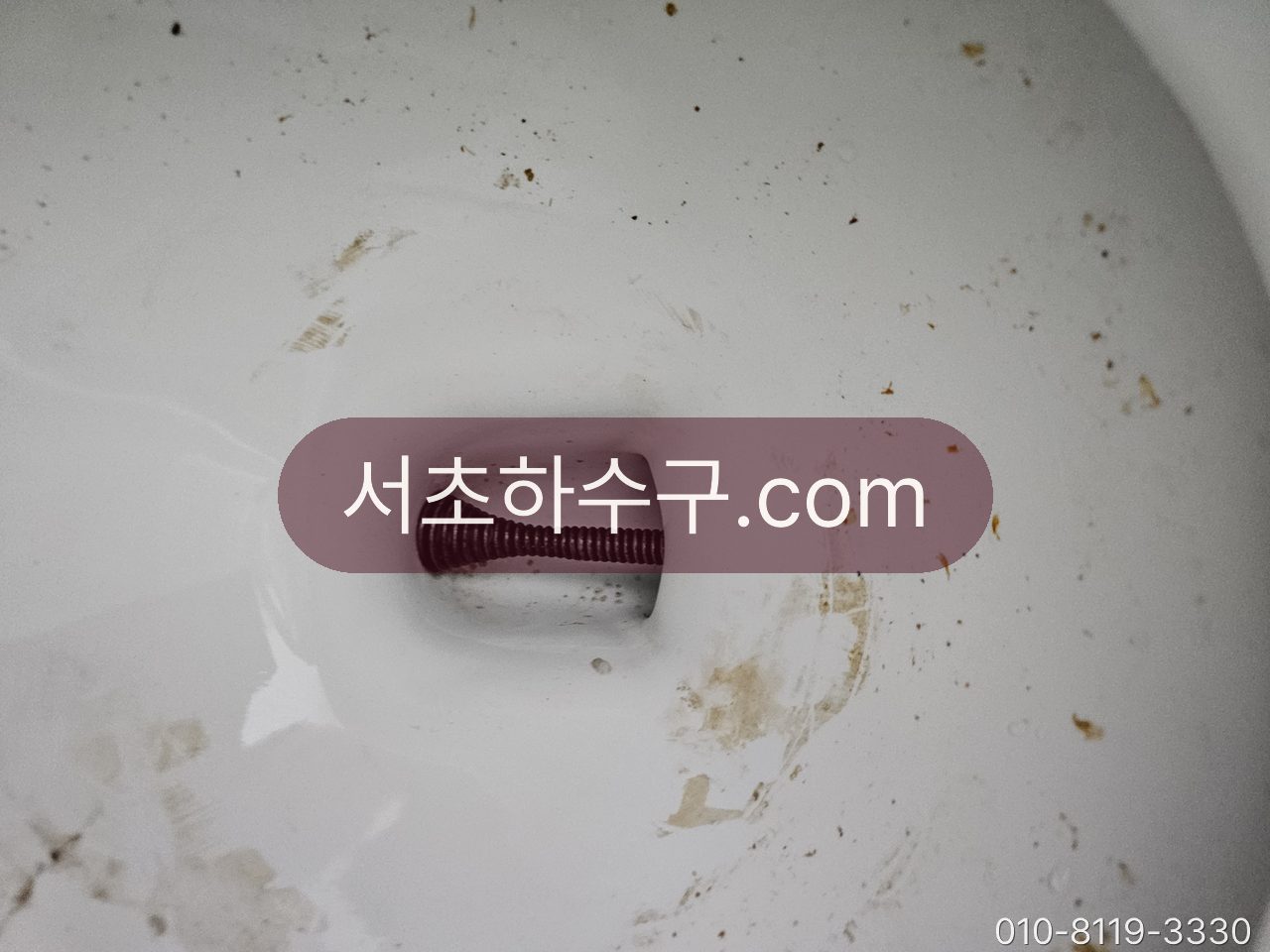변기 트랩 안으로 관통 케이블을 넣어 작업하는 장면